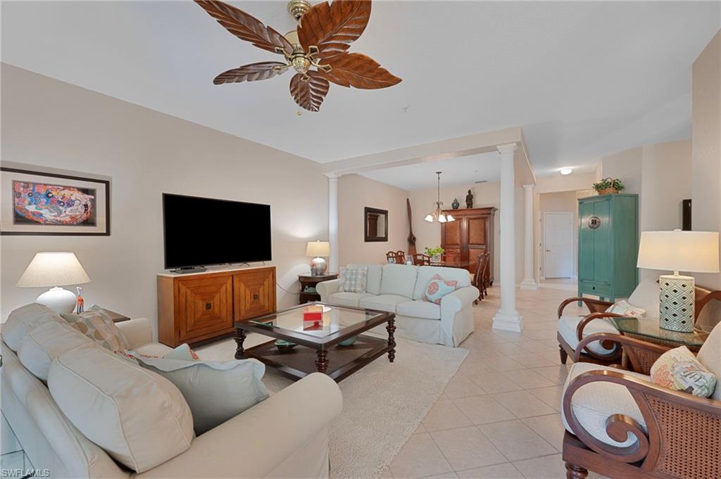 4695 Winged Foot Court, Unit 101 Naples, FL 34112 - Photo 3 of 23 a living room with furniture and a flat screen tv
