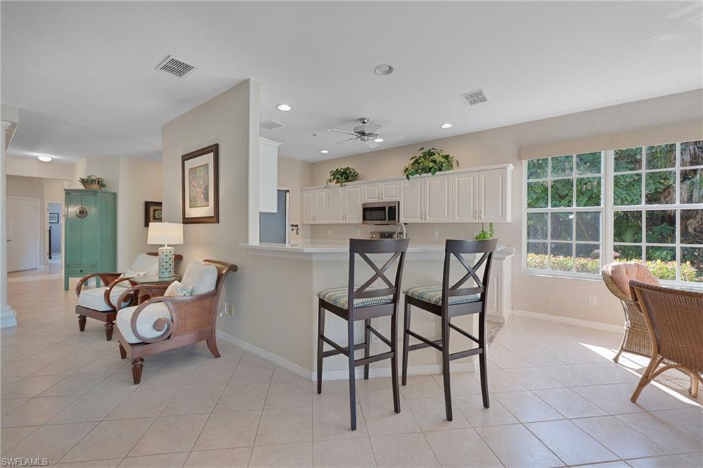 4695 Winged Foot Court, Unit 101 Naples, FL 34112 - Photo 7 of 23 a view of a dining room with furniture