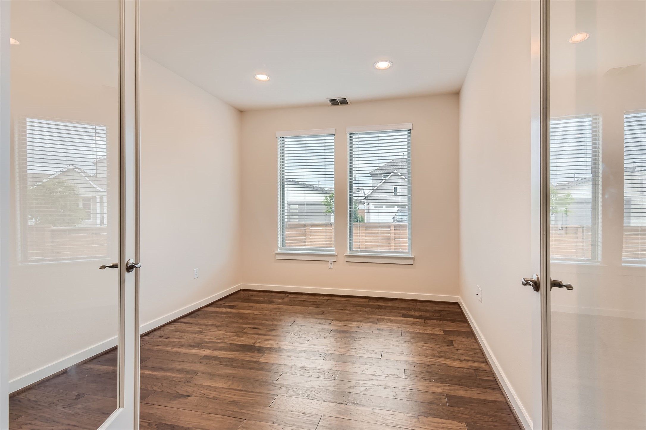 8313 Spire View Austin, TX 78744 - Photo 9 of 33 Hardwood floors and natural light define this versatile space, perfect for an office or den.