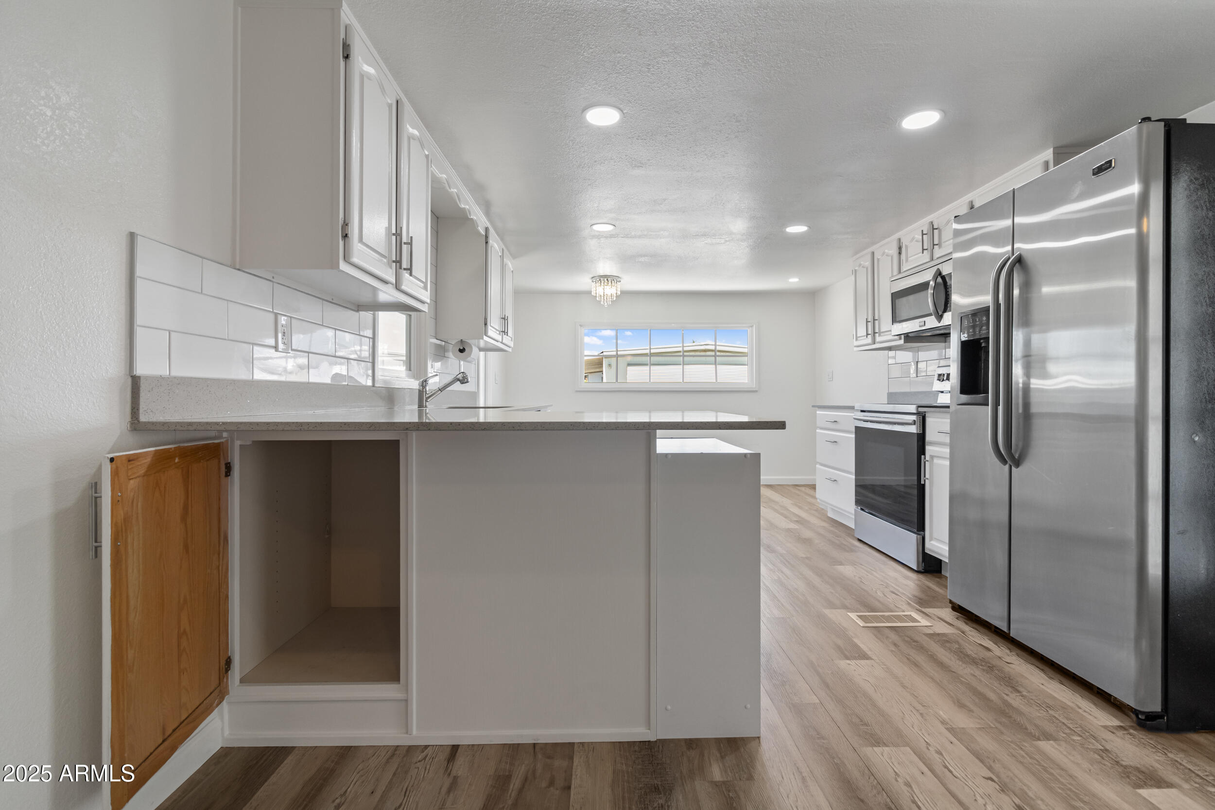 535 South Alma School Road, Unit 17 Mesa, AZ 85210 - Photo 12 of 58 a kitchen with stainless steel appliances granite countertop a refrigerator and a sink