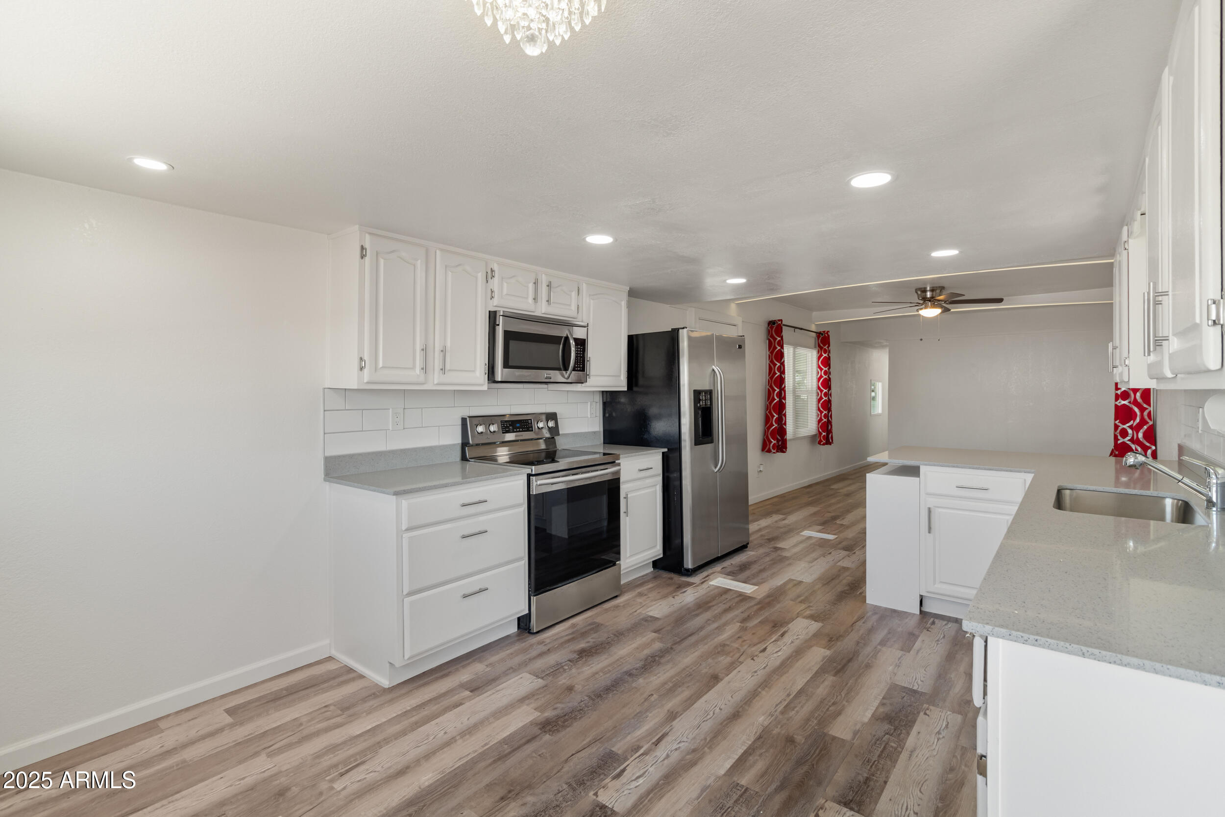 535 South Alma School Road, Unit 17 Mesa, AZ 85210 - Photo 13 of 58 a kitchen with white cabinets and stainless steel appliances