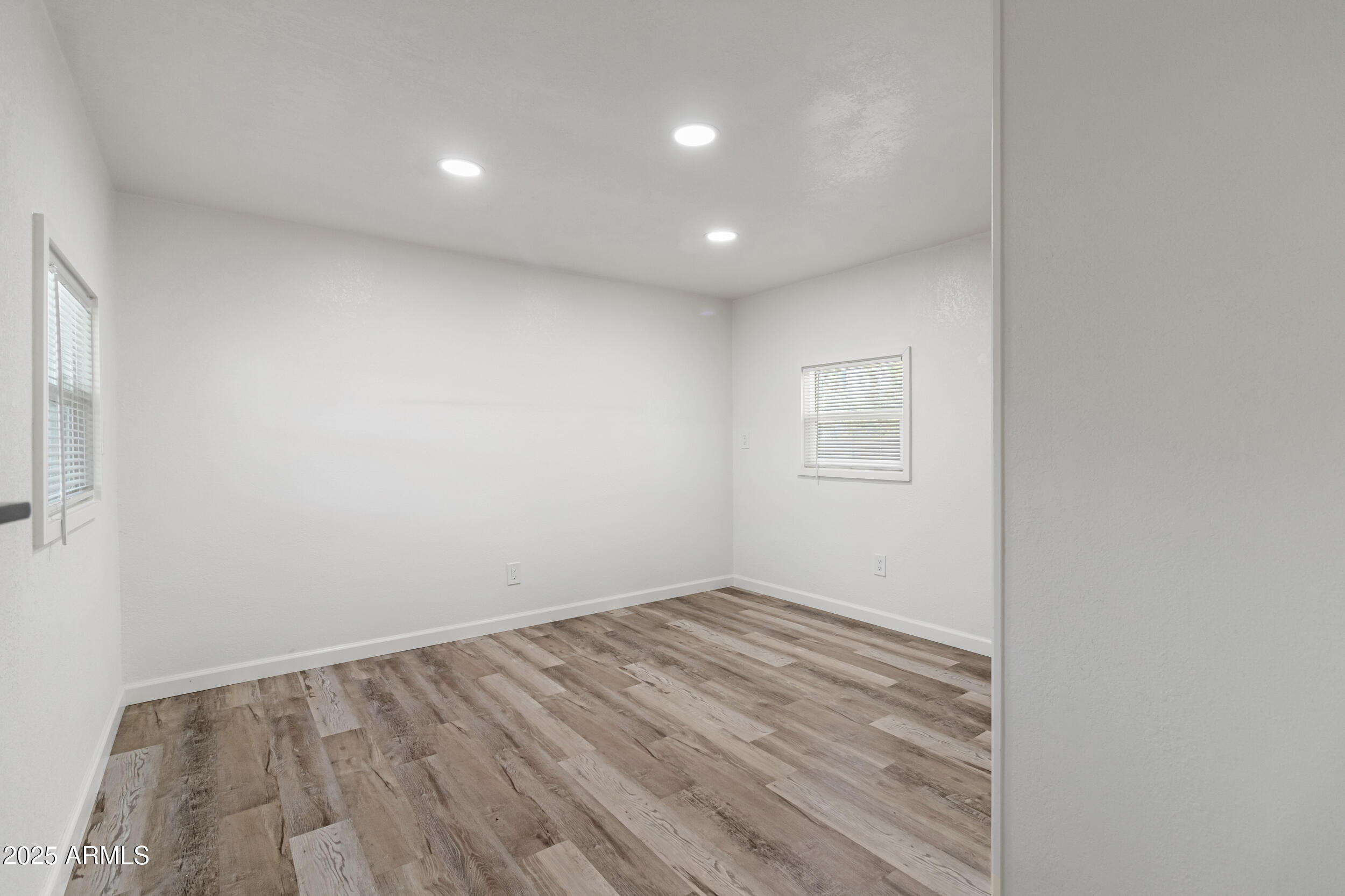 535 South Alma School Road, Unit 17 Mesa, AZ 85210 - Photo 21 of 58 a view of room with window and wooden floor