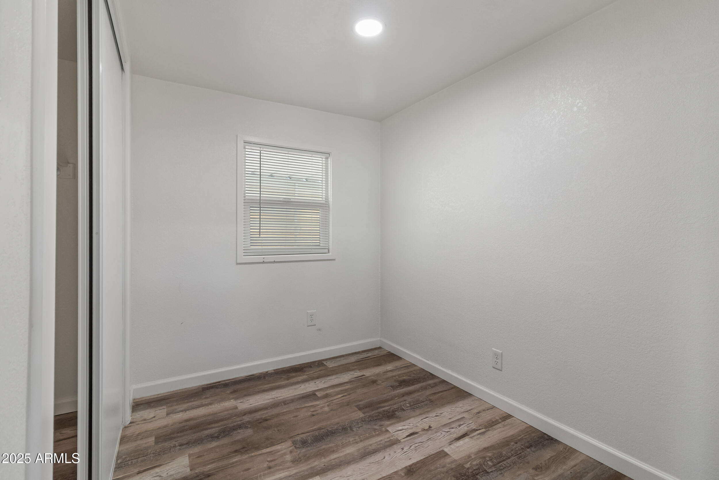 535 South Alma School Road, Unit 17 Mesa, AZ 85210 - Photo 23 of 58 an empty room with wooden floor and windows