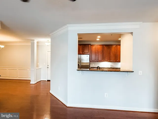 a view of a room with wooden floor and cabinet