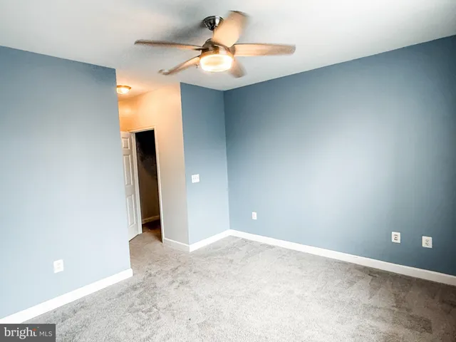 a view of a room with a sink and a chandelier fan