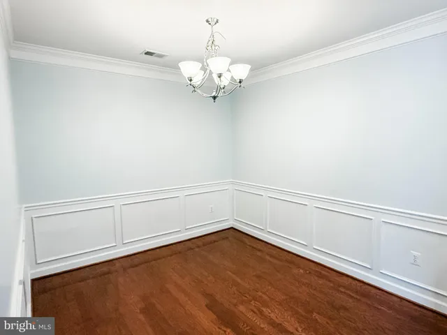 a view of a chandelier with wooden floor