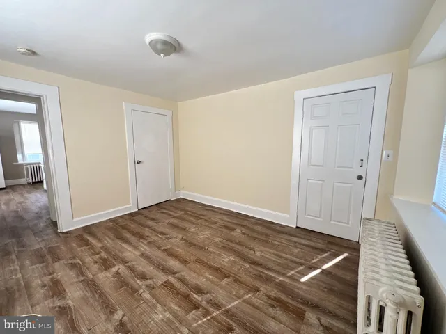 a room with a stove top oven a sink and a window