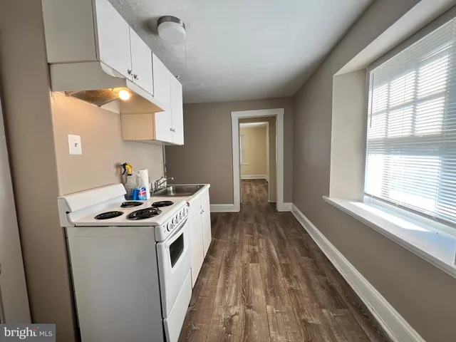 a kitchen with white cabinets and white appliances