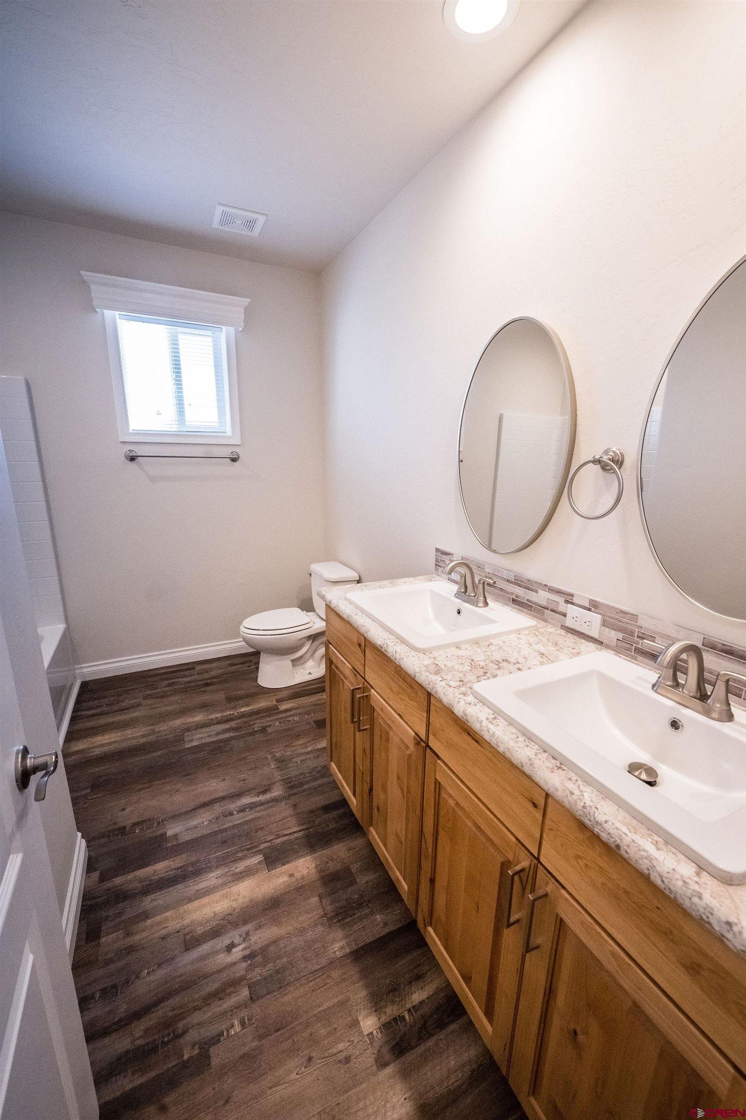 1246 H25 Road Delta, CO 81416 - Photo 11 of 31 a spacious bathroom with a double vanity sink and a mirror