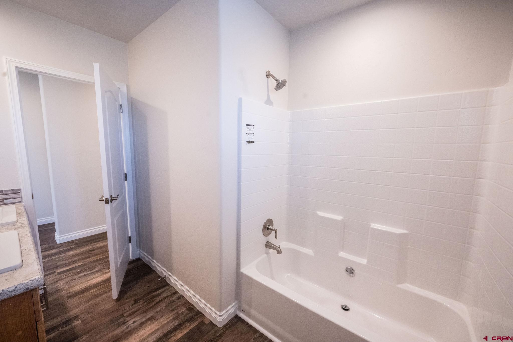 1246 H25 Road Delta, CO 81416 - Photo 12 of 31 a bathroom with a bathtub and a shower