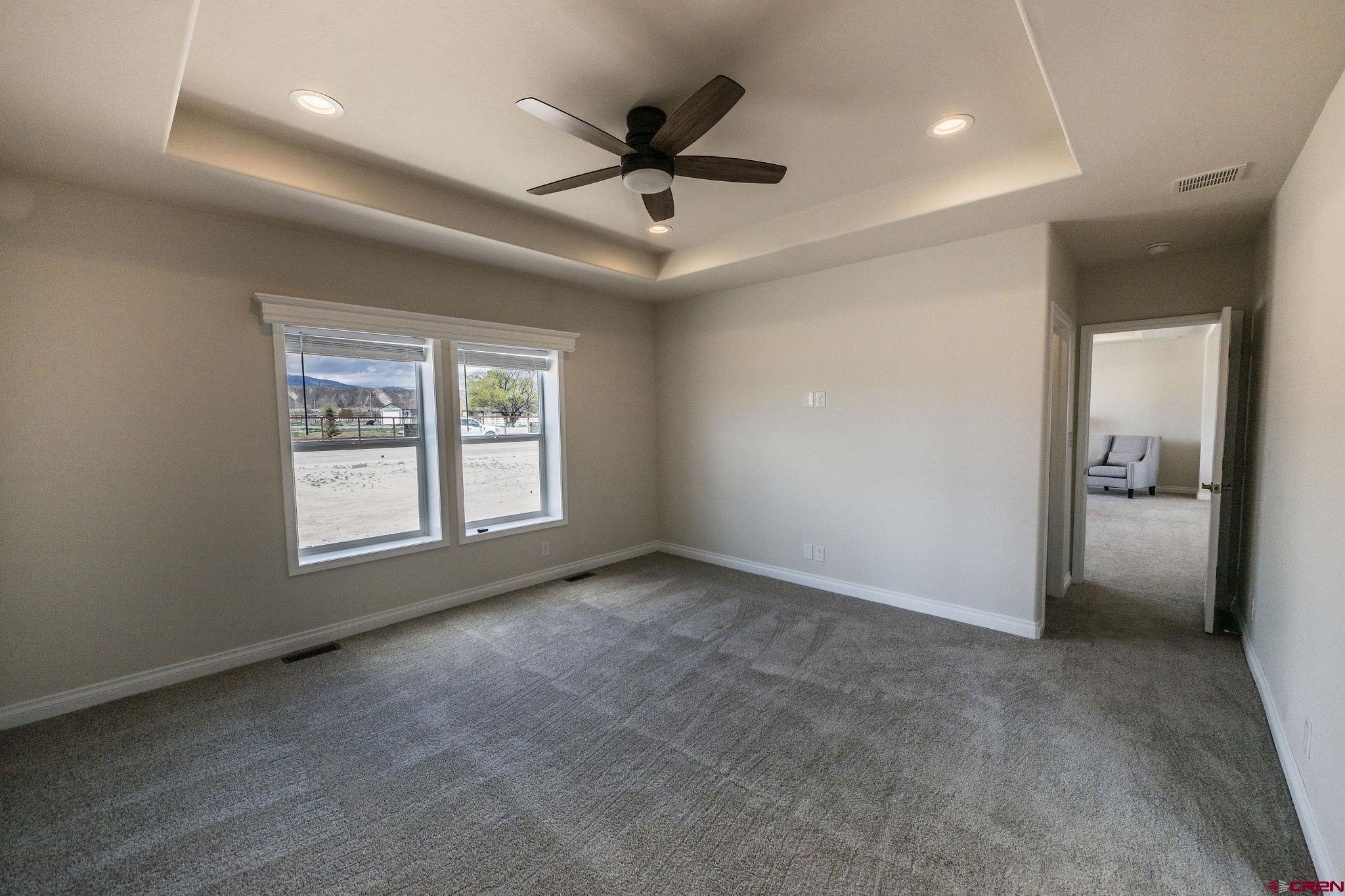 1246 H25 Road Delta, CO 81416 - Photo 13 of 31 an empty room with windows and ceiling fan