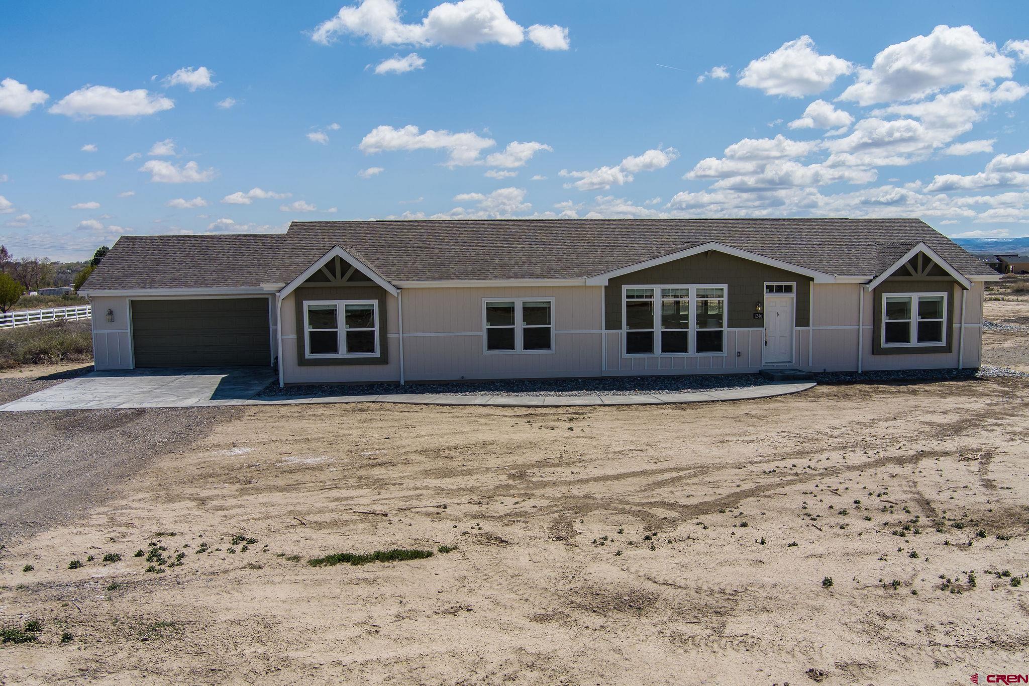 1246 H25 Road Delta, CO 81416 - Photo 19 of 31 a front view of a house with a yard