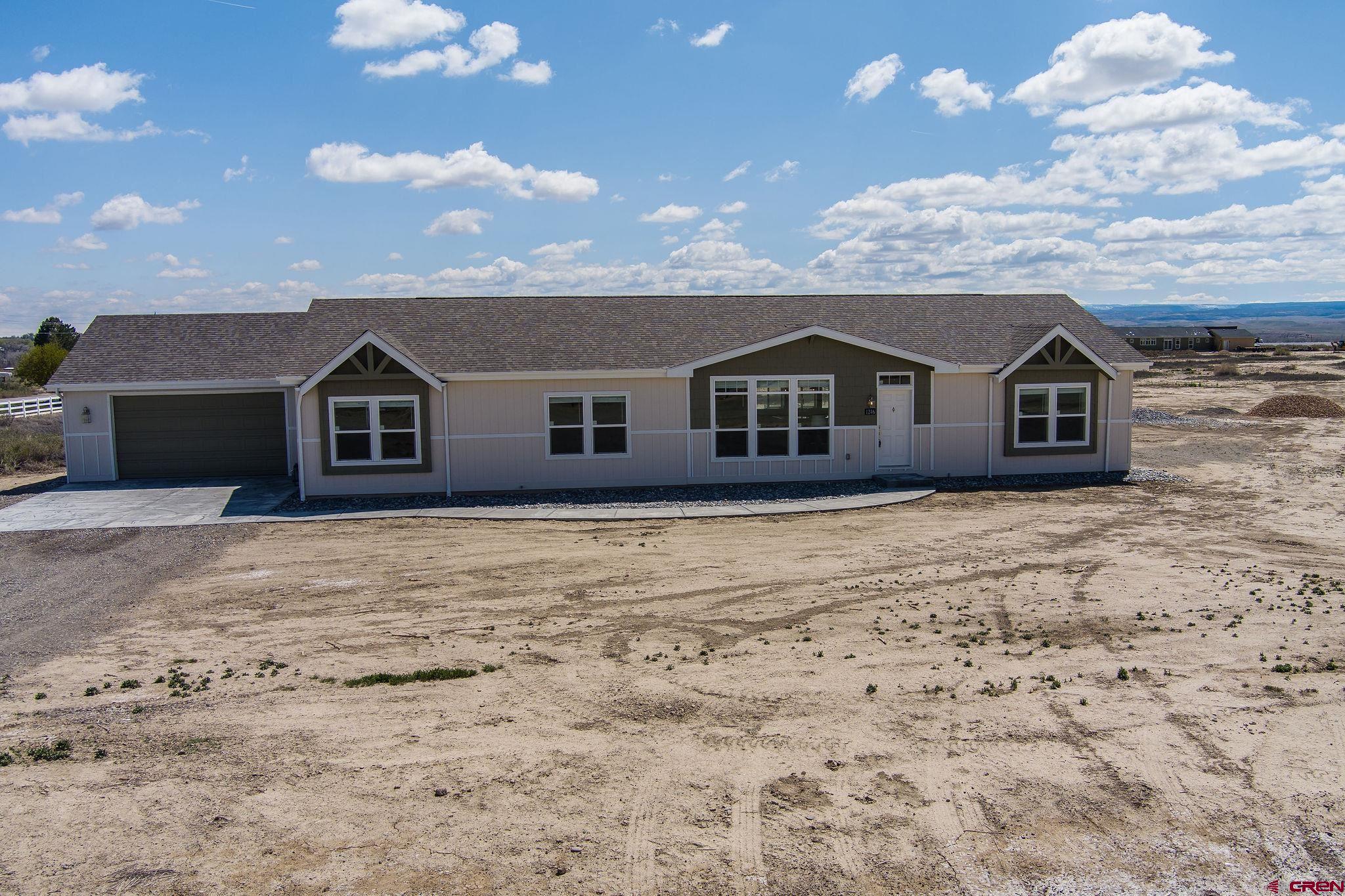 1246 H25 Road Delta, CO 81416 - Photo 31 of 31 a view of a house with a yard