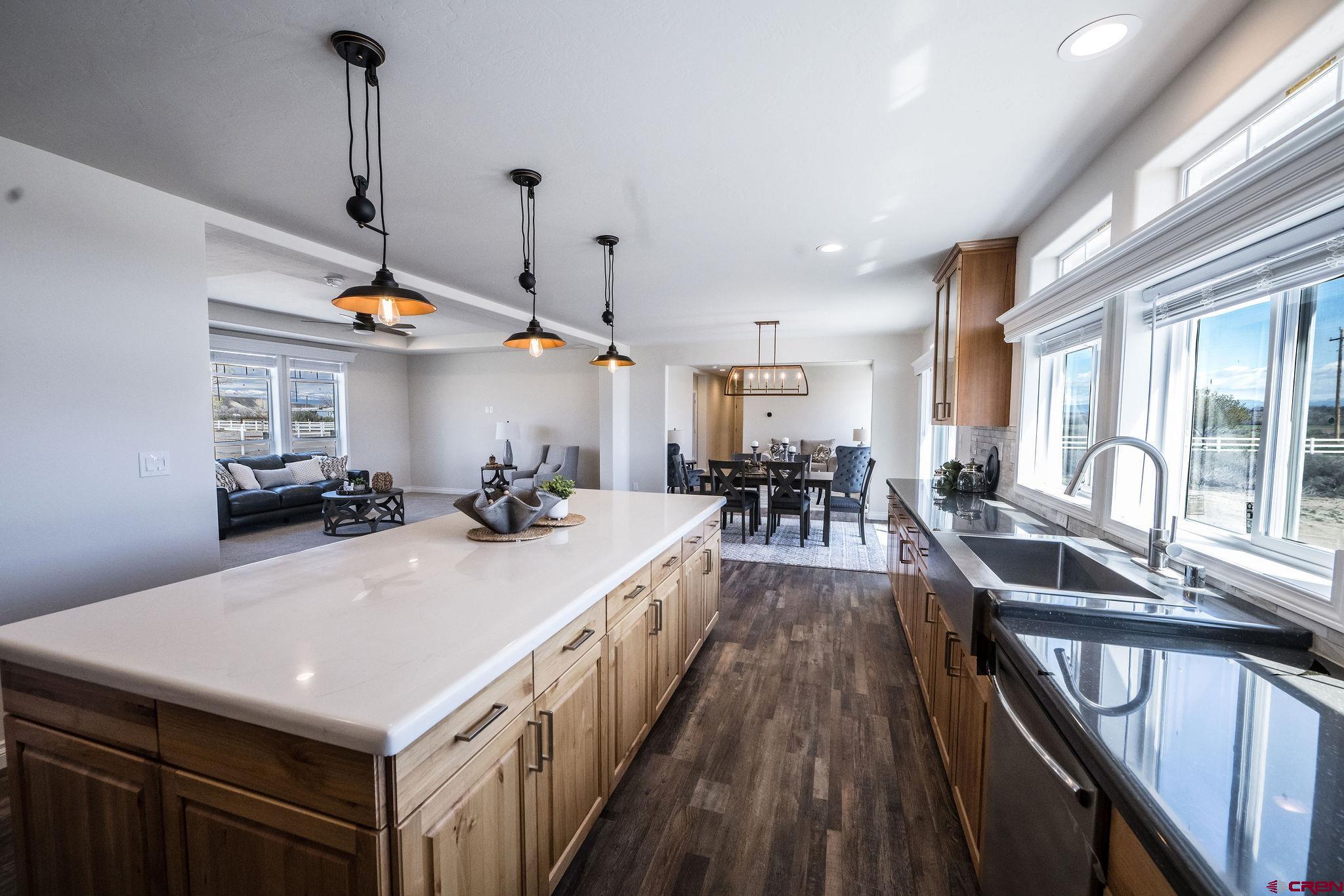 1246 H25 Road Delta, CO 81416 - Photo 4 of 31 a kitchen with stainless steel appliances a table a sink a stove and a wooden floors