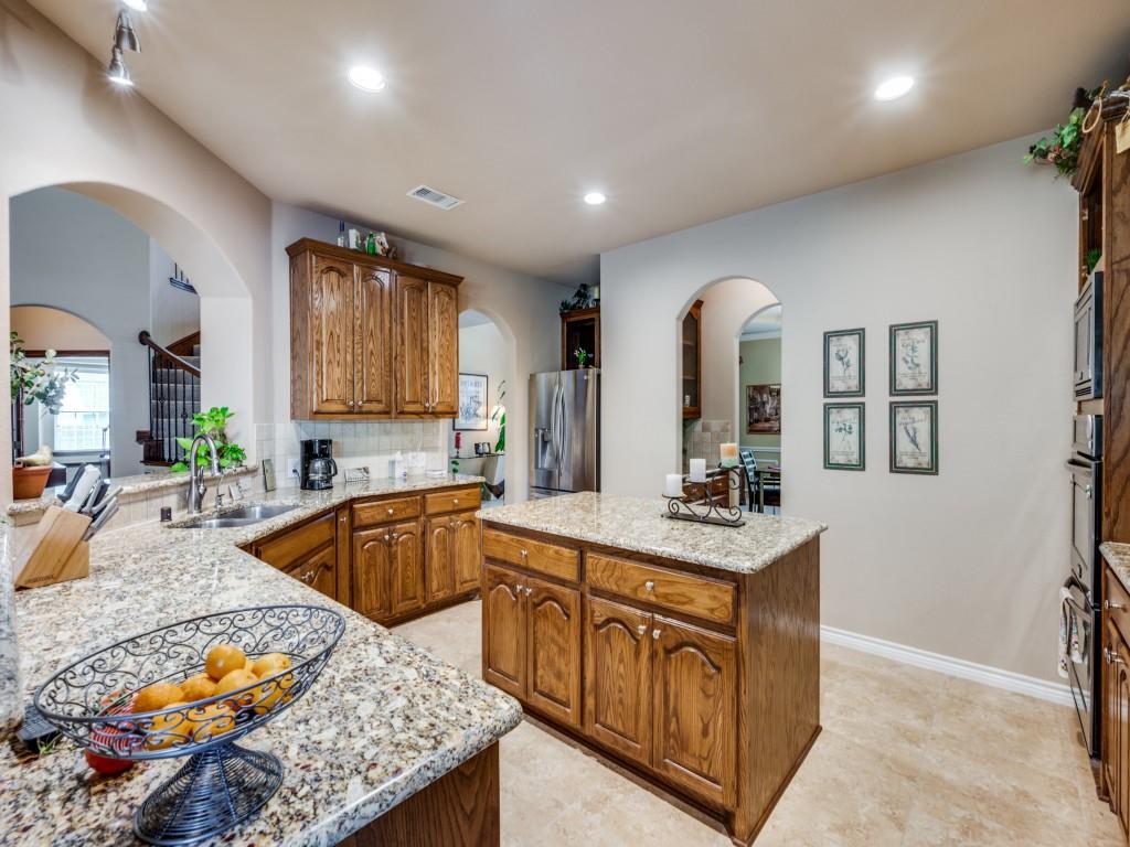 8305 Bishop Pine Road Denton, TX 76208 - Photo 11 of 27 a kitchen with stainless steel appliances granite countertop a sink stove and cabinets