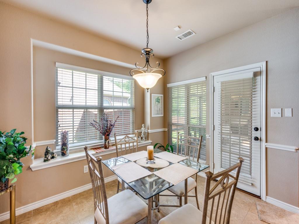 8305 Bishop Pine Road Denton, TX 76208 - Photo 12 of 27 a dining room with furniture a chandelier and wooden floor