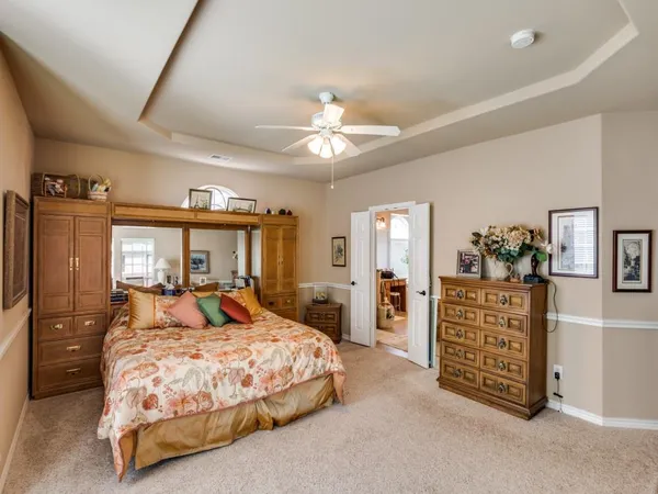 a bedroom with a bed dresser and a window