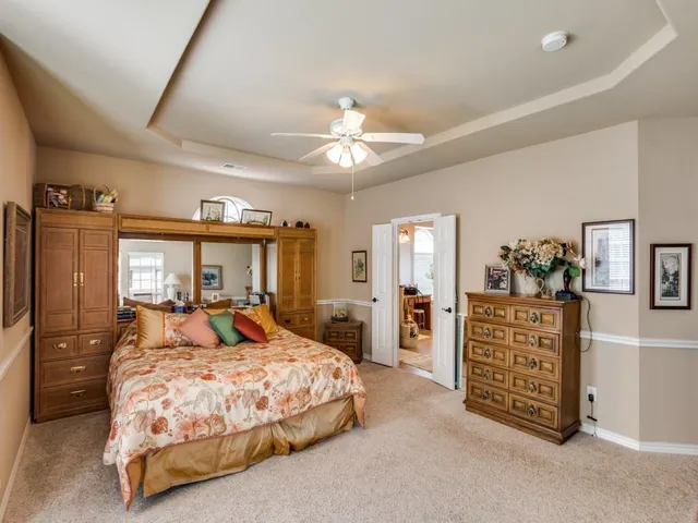 a bedroom with a bed dresser and a window