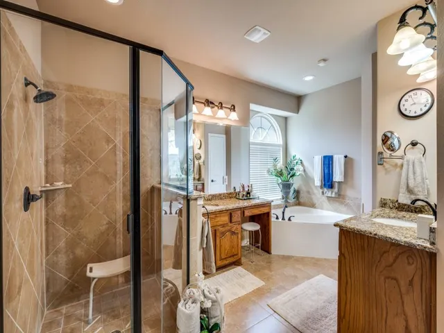 a bathroom with a tub sink and mirror