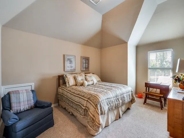 a bedroom with a bed and a couch