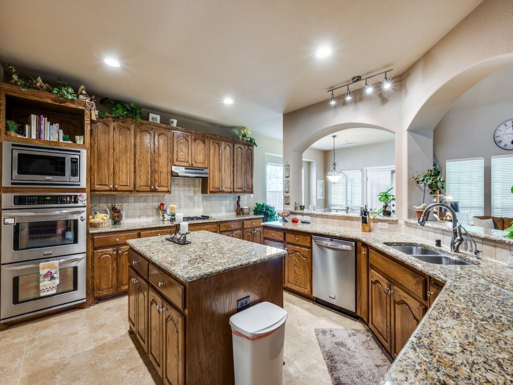 8305 Bishop Pine Road Denton, TX 76208 - Photo 10 of 27 a kitchen with a sink stove and microwave