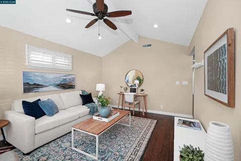 a living room with furniture and a wooden floor