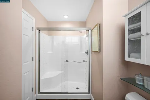 a view of a house with a small yard and wooden fence