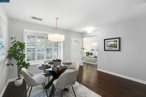 a view of a dining room with furniture window and wooden floor