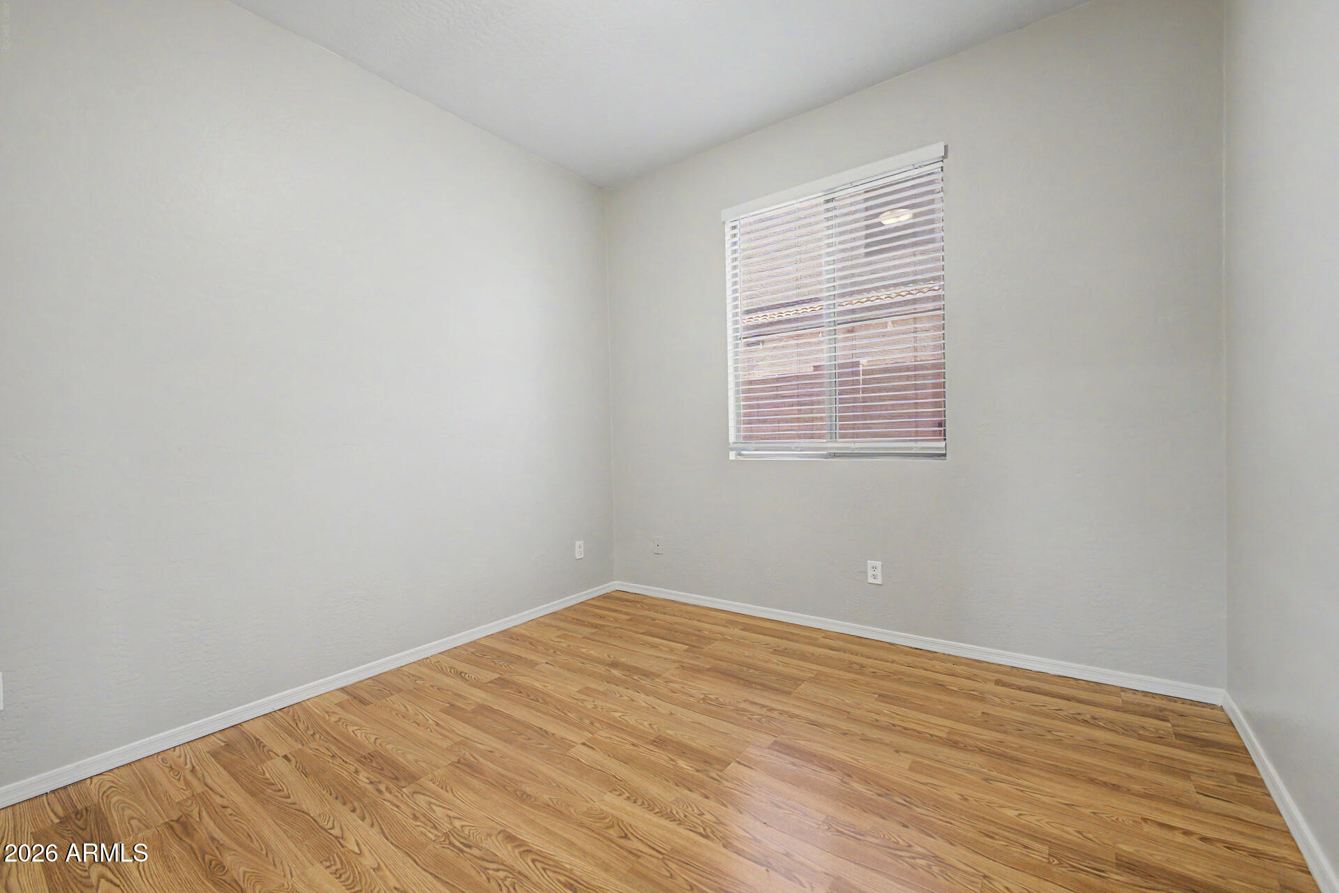 11199 West Monte Vista Road Avondale, AZ 85392 - Photo 20 of 36 a view of an empty room with wooden floor and a window