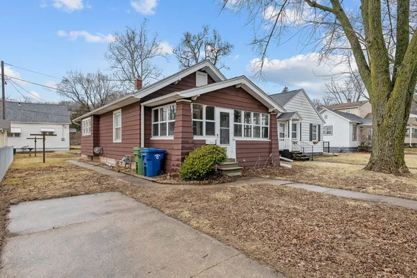 a view of a house with a yard covered in snow