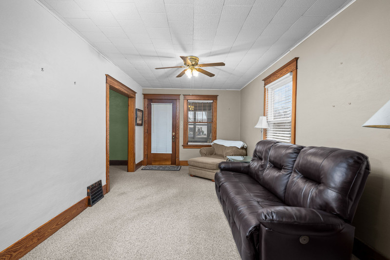 204 Adams Place Clinton, IA 52732 - Photo 11 of 20 a living room with furniture and a ceiling fan