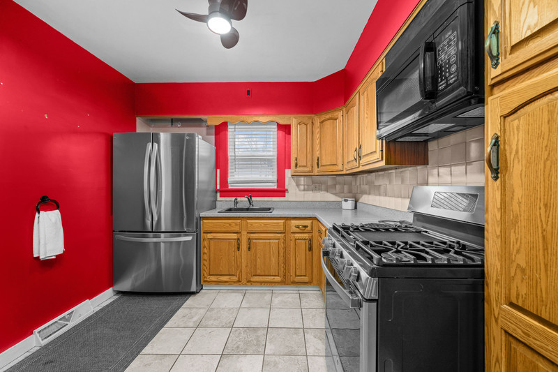 204 Adams Place Clinton, IA 52732 - Photo 14 of 20 a kitchen with stainless steel appliances granite countertop a stove a refrigerator and a sink