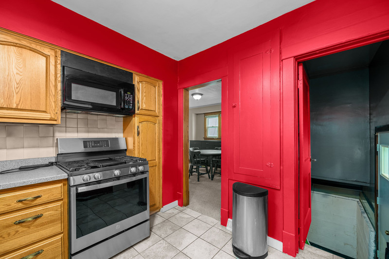 204 Adams Place Clinton, IA 52732 - Photo 15 of 20 a kitchen with stainless steel appliances kitchen island granite countertop a stove and a microwave