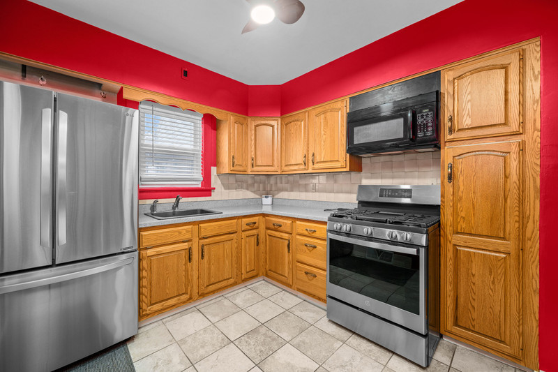 204 Adams Place Clinton, IA 52732 - Photo 16 of 20 a kitchen with stainless steel appliances granite countertop a stove top oven a refrigerator and a microwave