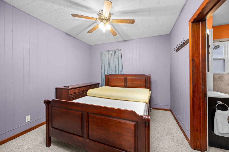 204 Adams Place Clinton, IA 52732 - Photo 17 of 20 a bedroom with a bed and a chandelier