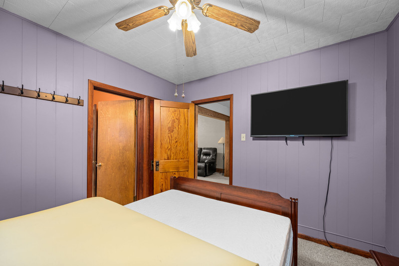 204 Adams Place Clinton, IA 52732 - Photo 18 of 20 a bedroom with a bed and a flat screen tv