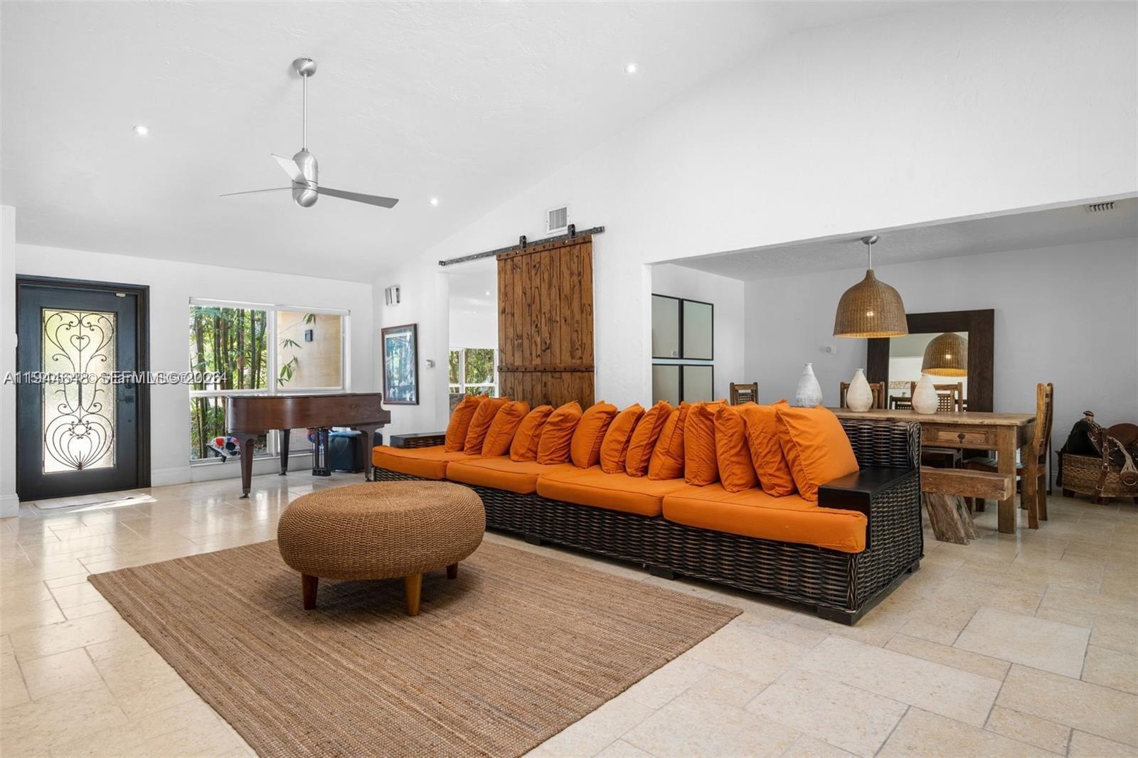 6411 Southwest 185th Way Southwest Ranches, FL 33332 - Photo 11 of 32 a living room with furniture a rug and a chandelier