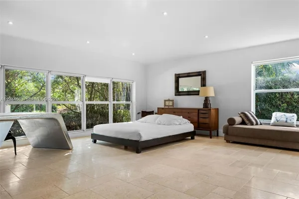 a living room with a bed couch and a large window