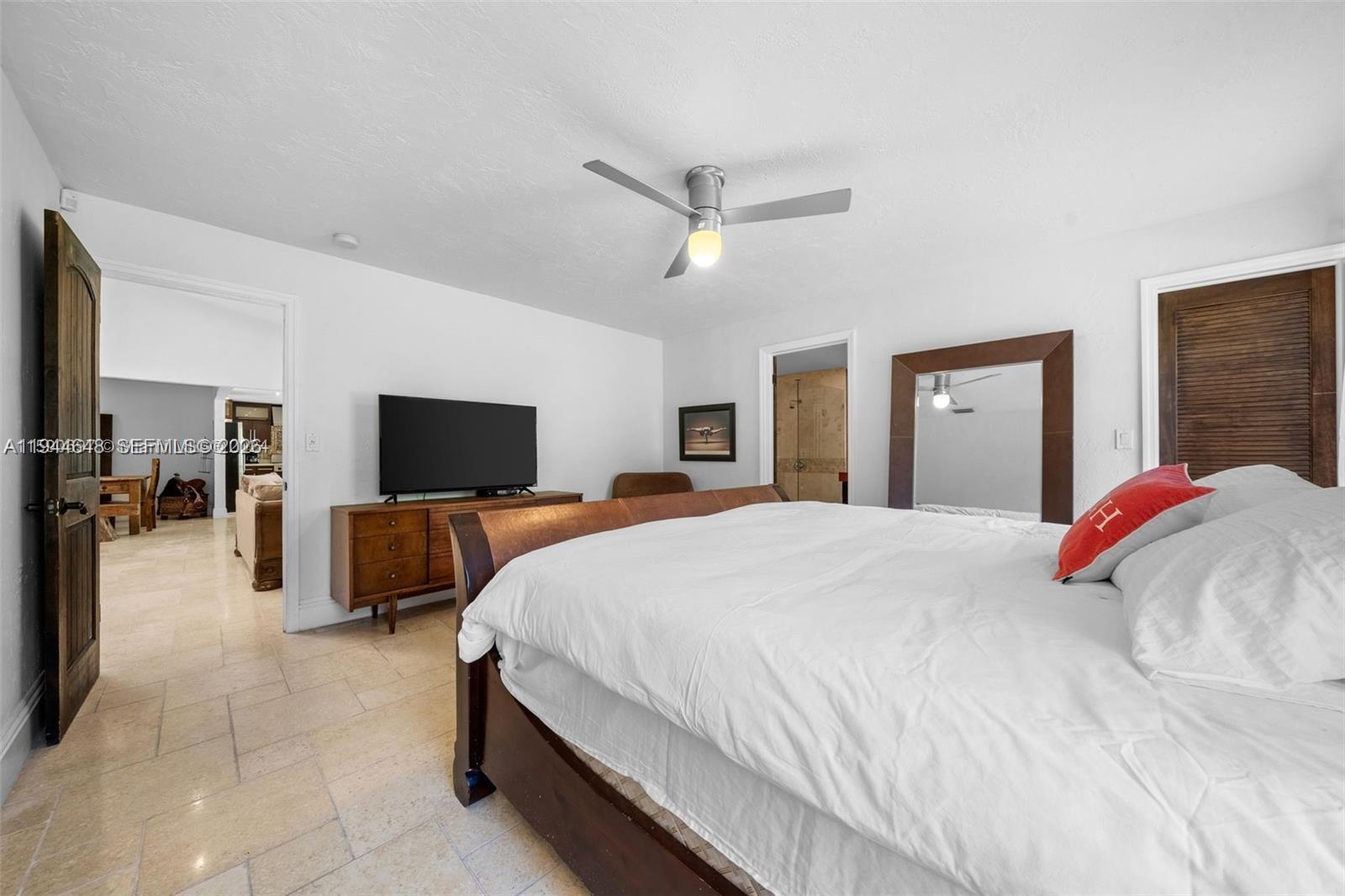 6411 Southwest 185th Way Southwest Ranches, FL 33332 - Photo 16 of 32 a bedroom with a bed and a flat screen tv