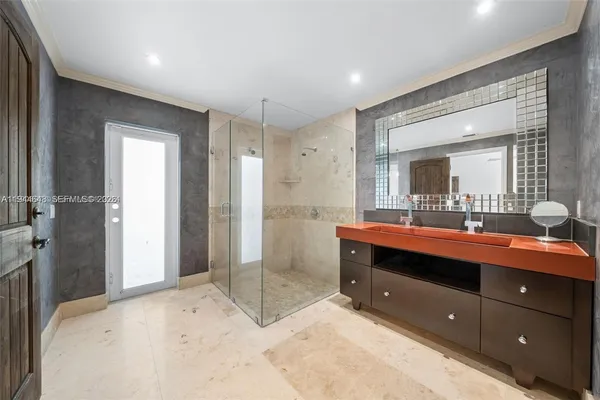 a spacious bathroom with a shower sink and mirror
