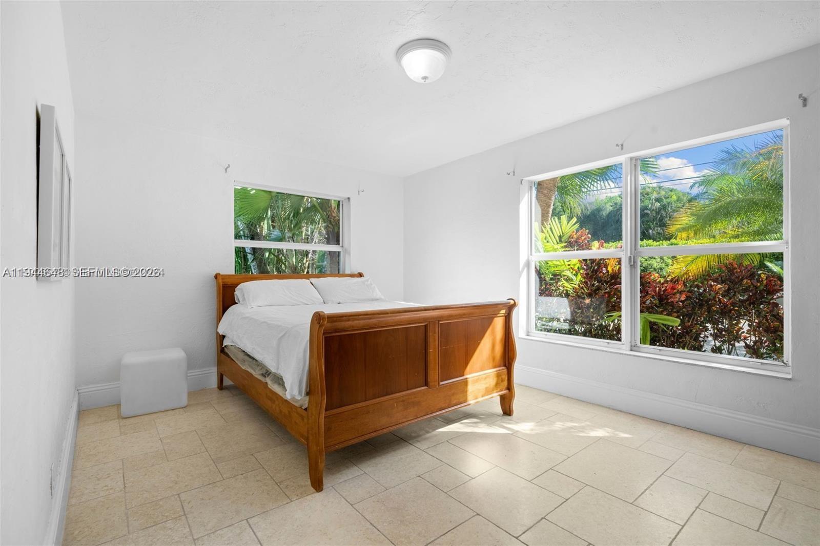 6411 Southwest 185th Way Southwest Ranches, FL 33332 - Photo 19 of 32 a bedroom with a bed and a large window