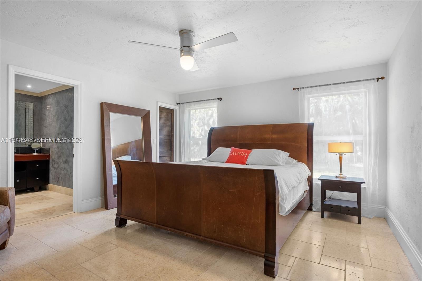 6411 Southwest 185th Way Southwest Ranches, FL 33332 - Photo 20 of 32 a bed room with a bed and a chandelier