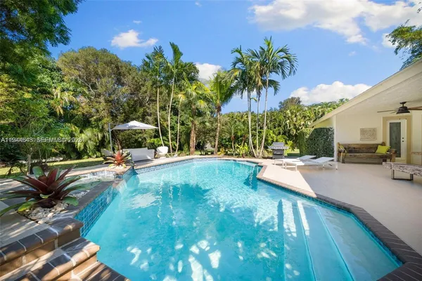 a view of a swimming pool with chairs