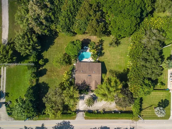 an aerial view of a residential houses with outdoor space