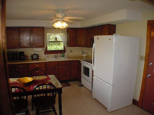 355 Porter Road Harmon, IL 61042 - Photo 2 of 11 a kitchen with a sink a refrigerator and a stove top oven