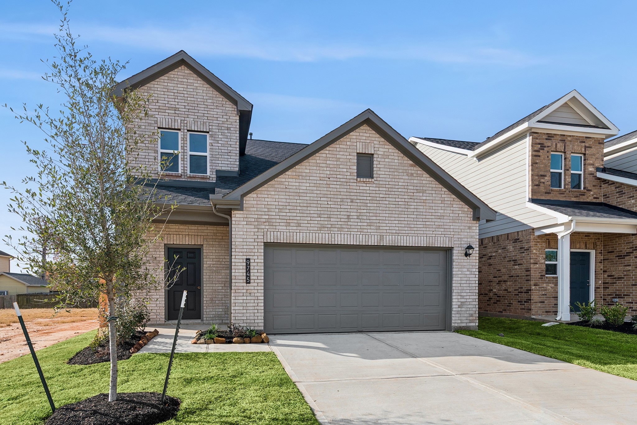 9745 Enclave Ridge Road Willis, TX 77318 - Photo 2 of 27 a front view of a house with a yard and garage