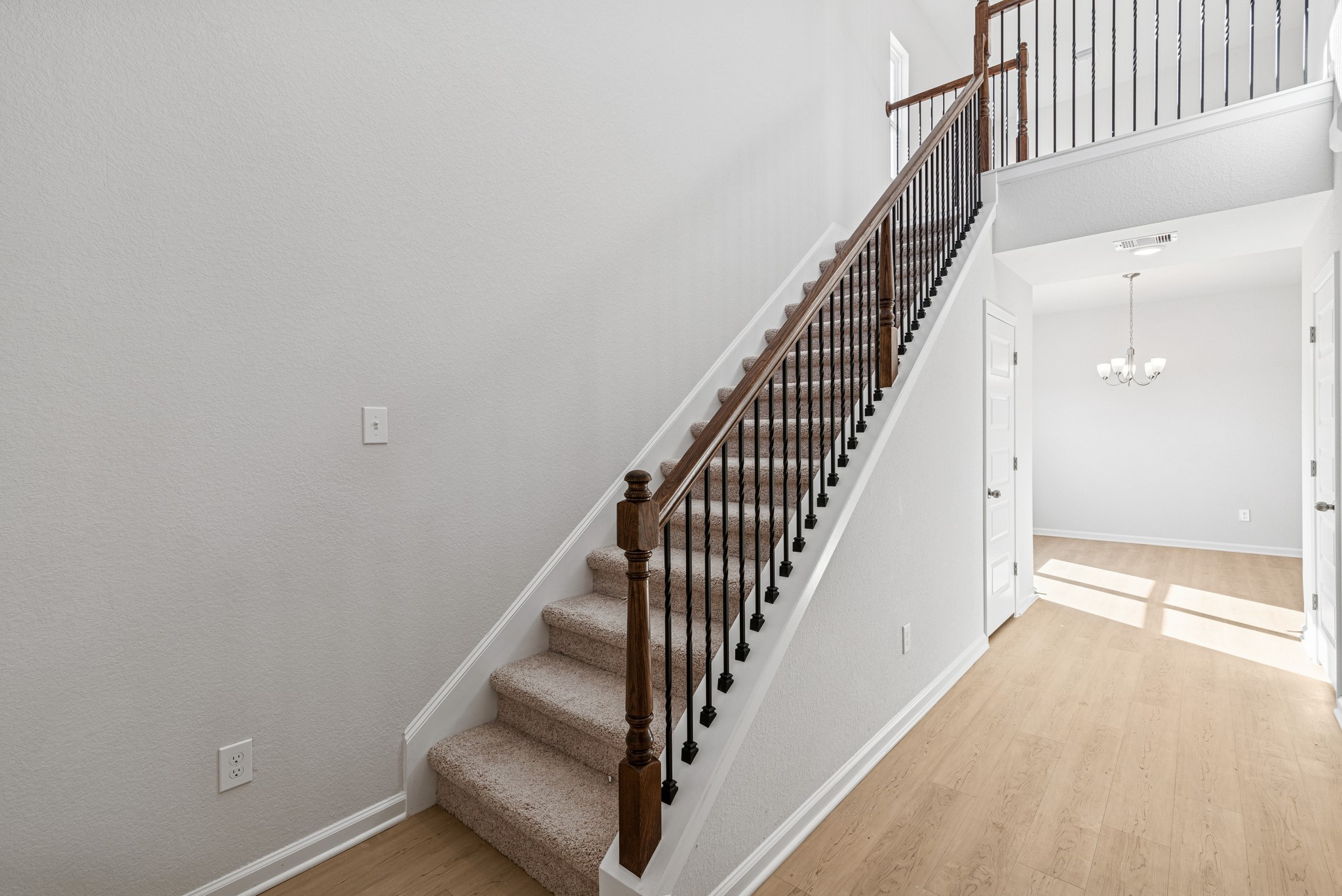 9745 Enclave Ridge Road Willis, TX 77318 - Photo 3 of 27 a view of staircase with wooden floor and white walls