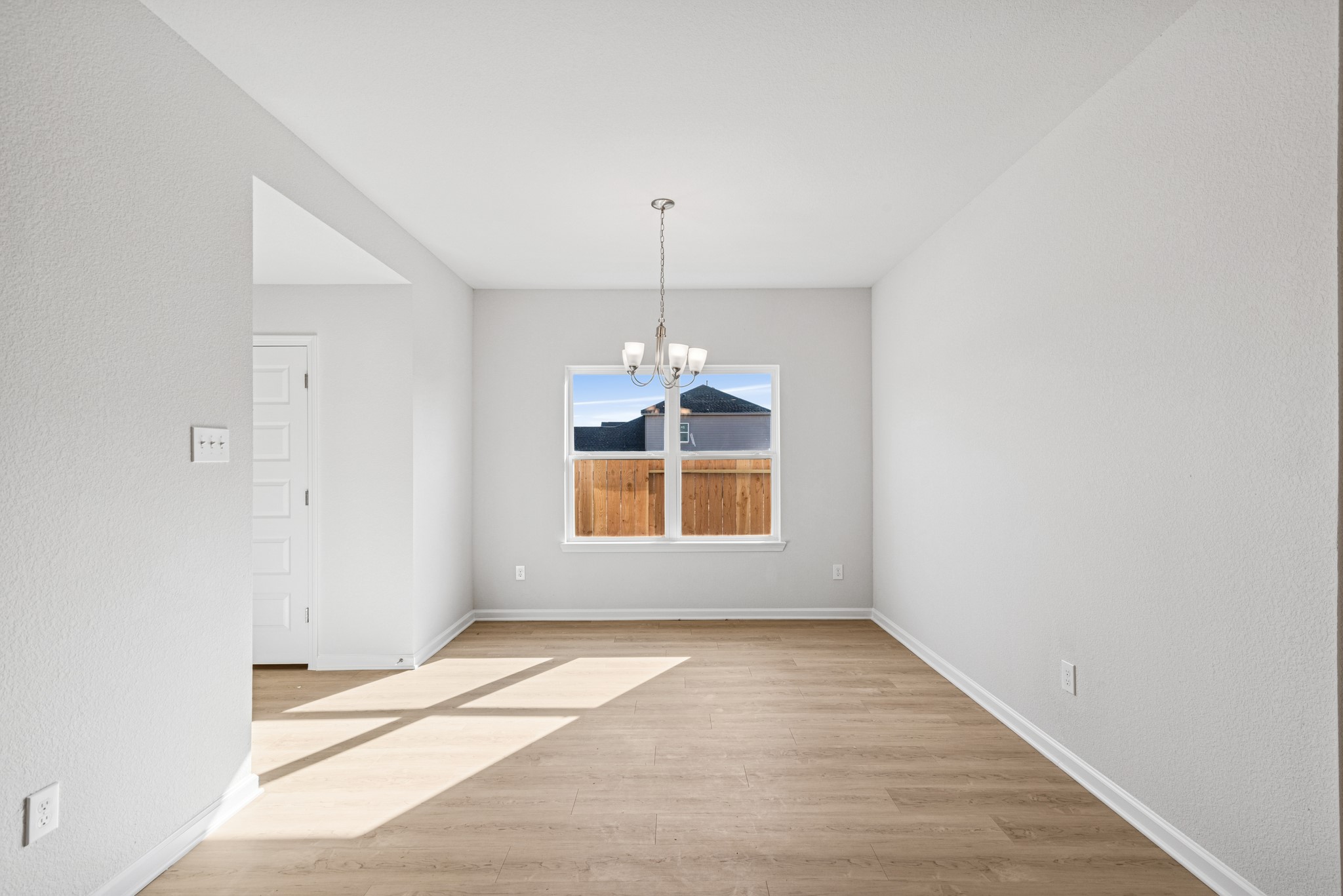 9745 Enclave Ridge Road Willis, TX 77318 - Photo 4 of 27 an empty room with windows and entrance