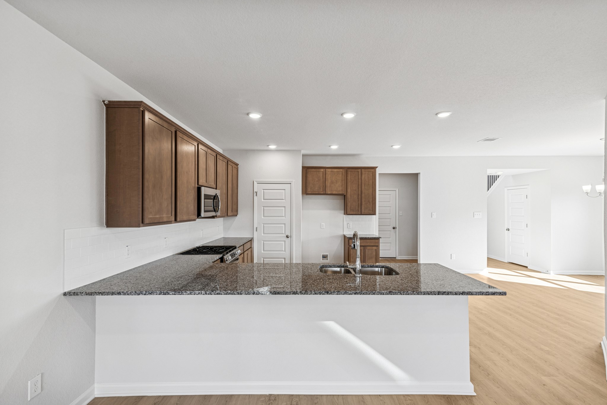 9745 Enclave Ridge Road Willis, TX 77318 - Photo 7 of 27 a kitchen with stainless steel appliances granite countertop a sink refrigerator and cabinets