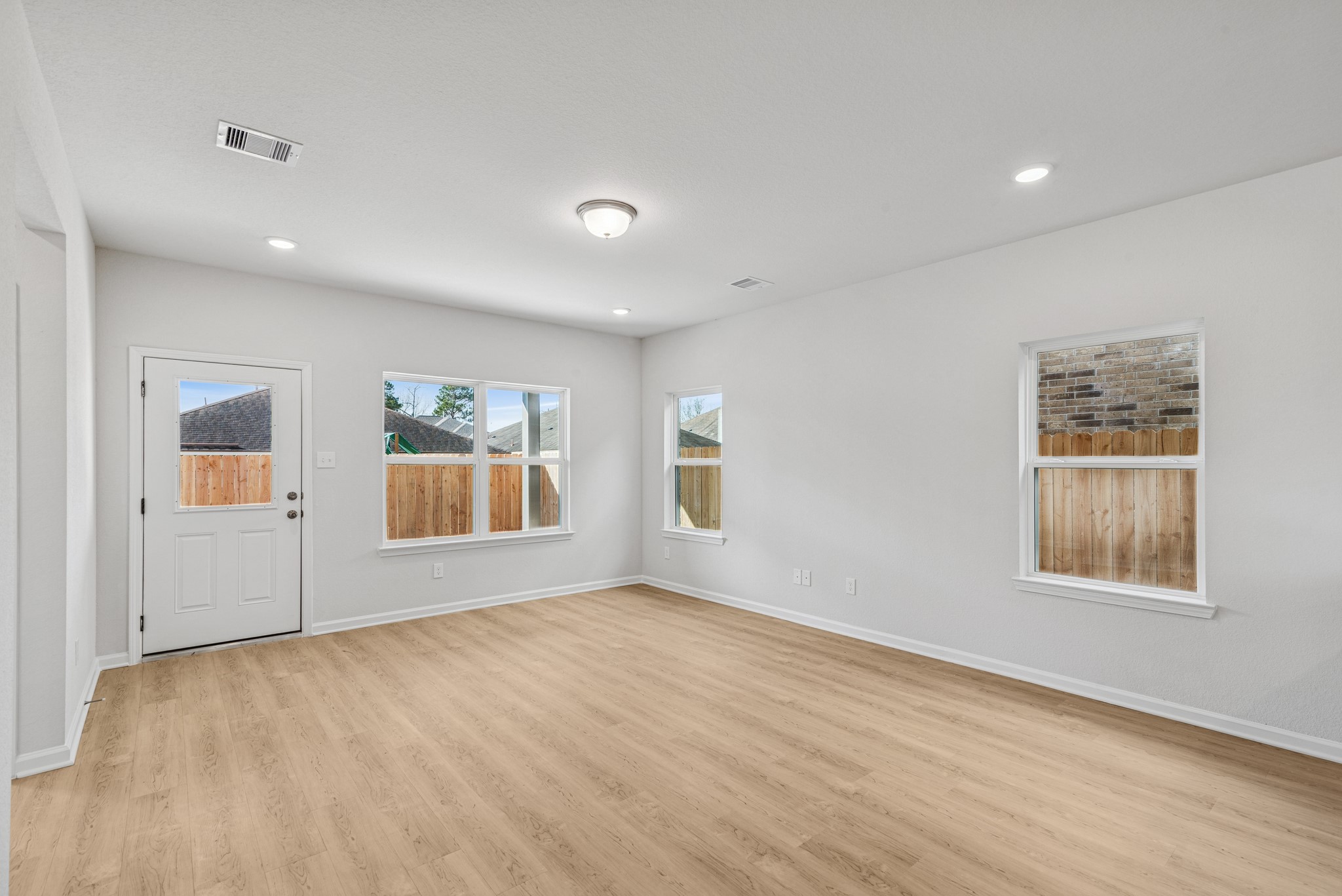 9745 Enclave Ridge Road Willis, TX 77318 - Photo 8 of 27 a view of an empty room with a window and wooden floor
